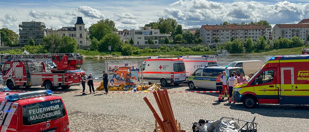 Einsatzfahrzeuge stehen am Elbufer. Die Hüpfburg soll in die Elbe geweht worden sein. Aktuell sei niemand mehr in Gefahr, sagte ein Sprecher der Polizei der Deutschen Presse-Agentur. Foto: -/dpa-Zentralbild/dpa +++ dpa-Bildfunk +++