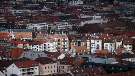 Blick aus der Vogelperspektive auf die Stuttgarter Innenstadt. Vereinzelte Gebäude werden durch ein Wolkenloch von der Sonne angestrahlt.