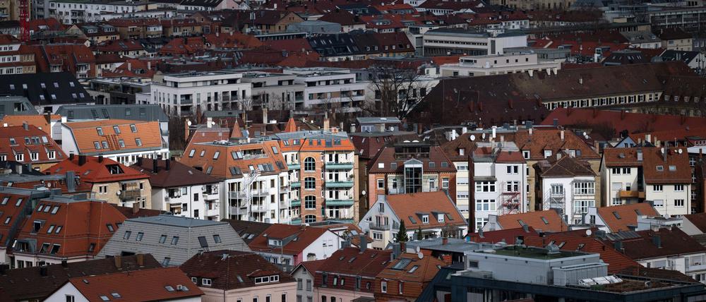 Blick aus der Vogelperspektive auf die Stuttgarter Innenstadt. Vereinzelte Gebäude werden durch ein Wolkenloch von der Sonne angestrahlt.