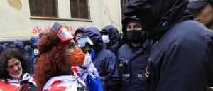 Eine Demonstrantin trägt eine Nationalflagge.