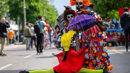 Feiernde in Kostümen stehen vor der Parade zum 26. Karneval der Kulturen auf der Straße. (Archivbild)
