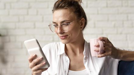 Woman checking her phone, looking at news, reading
