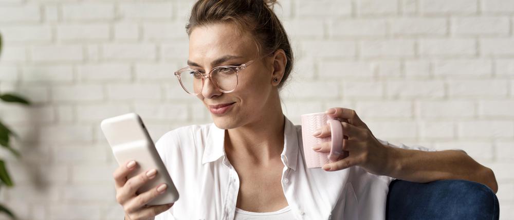 Woman checking her phone, looking at news, reading