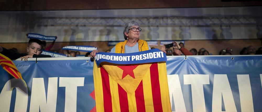 Eine Anhängerin des ehemaligen katalanischen Regionalpräsidenten Carles Puigdemont hält eine «estelada» oder auch Unabhängigkeitsflagge während einer Wahlkampfveranstaltung.