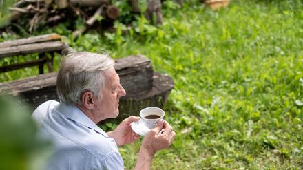 Elderly man sipping tea, with a focus on relaxation and the simplicity of enjoying nature, ideal for leisure and retirement, senior insurance concepts. High quality photo