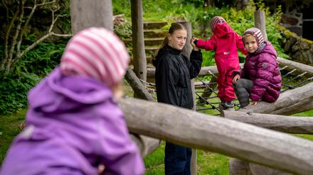 Poula Djurhuus (2nd L) plays with children Sol, Liv and Edna in Torshavn, Faroe Islands, on June 7, 2024. Poula usually attends 8th grade, but since schools and institutions are closed due to the strike, she is instead taking care of her three cousins during the day. Since May 14, 2024, truck drivers, port workers and several others have been on strike in the Faroe Islands due to a wage conflict, which means that gasoline has become a scarce commodity and many shelves in the supermarkets are empty. (Photo by Ida Marie Odgaard / Ritzau Scanpix / AFP) / Denmark OUT