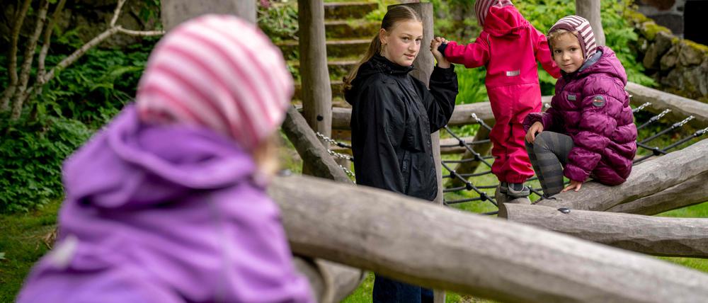 Poula Djurhuus (2nd L) plays with children Sol, Liv and Edna in Torshavn, Faroe Islands, on June 7, 2024. Poula usually attends 8th grade, but since schools and institutions are closed due to the strike, she is instead taking care of her three cousins during the day. Since May 14, 2024, truck drivers, port workers and several others have been on strike in the Faroe Islands due to a wage conflict, which means that gasoline has become a scarce commodity and many shelves in the supermarkets are empty. (Photo by Ida Marie Odgaard / Ritzau Scanpix / AFP) / Denmark OUT
