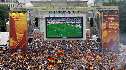 Tausende Zuschauer verfolgen auf der Fanmeile am Brandenburger Tor in Berlin das WM-Fußballspiel zwischen Deutschland und Argentinien im Jahr 2006.