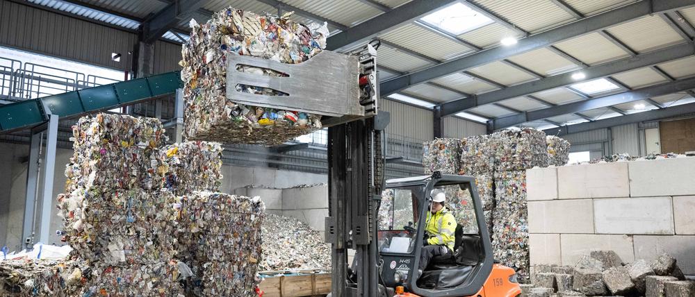 Ein Mitarbeiter hebt mit einem Gabelstapler in Ballen gepressten Aluminiumabfall aus der Gelben Tonne in einer Halle des neuen Werk II der Recyclingfirma PreZero Pyral.