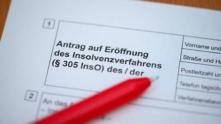 Ein Kugelschreiber liegt auf einem Antrag zur Eröffnung eines Insolvenzverfahrens.
