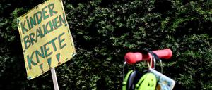 „Kinder brauchen Knete“ steht auf einem Schild bei einer Demonstration.