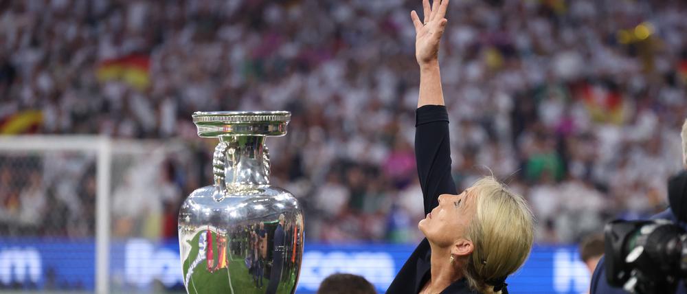June 14, 2024, Munich: Munich, Germany, 14th June 2024. Heidi Beckenbauer reaches towards the skies after she carried and placed the trophy in memory of her father during the UEFA European Championships match at Allianz Arena, Munich. (Credit Image: © David Klein/CSM via ZUMA Press Wire