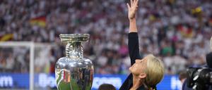 June 14, 2024, Munich: Munich, Germany, 14th June 2024. Heidi Beckenbauer reaches towards the skies after she carried and placed the trophy in memory of her father during the UEFA European Championships match at Allianz Arena, Munich. (Credit Image: © David Klein/CSM via ZUMA Press Wire
