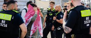 Pro-Palästinensische Demonstranten werden am Randes eines „Marschs für die Freiheit der Geiseln“ für die Freilassung der von der Hamas festgehaltenen israelischen Geiseln von Polizisten festgehalten.