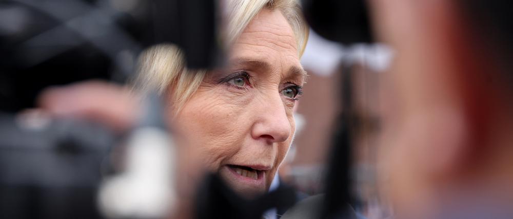 French far-right Rassemblement National (RN) party leader Marine Le Pen addresses media during a campaign visit at a market in Henin-Beamont, North of France on June 14, 2024, ahead of France's upcoming June 30 and July 7's snap elections for a new national parliament. France's Marine Le Pen on June 14, 2024 said her far-right party could win upcoming snap parliamentary elections and form a "national unity government" if it did. (Photo by Denis Charlet / AFP)