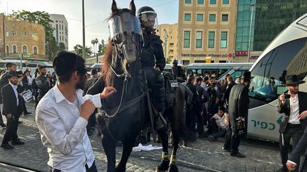 A police officer sits astride a horse as Ultra-Orthodox Jews block a tram in protest against attempts to change government policy that grants ultra-Orthodox Jews exemptions from military conscription, in Jerusalem, May 23, 2024. REUTERS/James Mackenzie