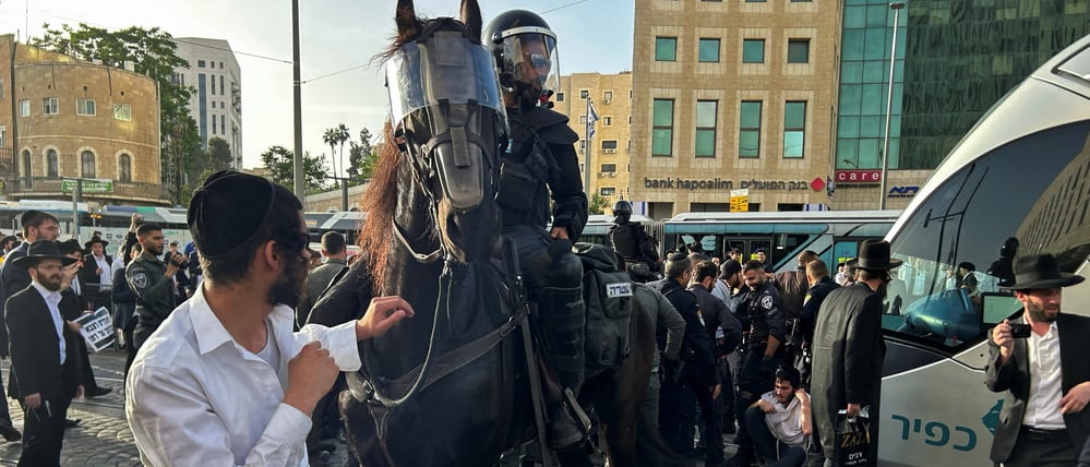 A police officer sits astride a horse as Ultra-Orthodox Jews block a tram in protest against attempts to change government policy that grants ultra-Orthodox Jews exemptions from military conscription, in Jerusalem, May 23, 2024. REUTERS/James Mackenzie