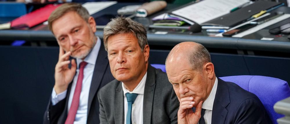 Christian Lindner (l-r, FDP), Bundesminister der Finanzen, Robert Habeck (Bündnis 90/Die Grünen), Bundesminister für Wirtschaft und Klimaschutz, und Bundeskanzler Olaf Scholz (SPD) nehmen an einer Sitzung des Bundestags teil.