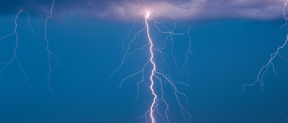 Brandenburg, Petersdorf: Blitze eines Gewitters leuchten am Abendhimmel.