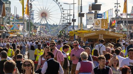 Wiesn-Besucher gehen 2023 über das Gelände.