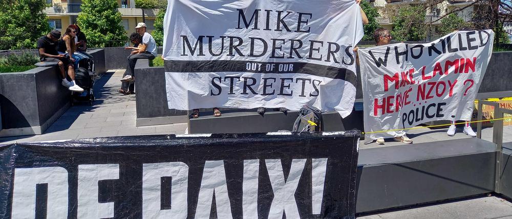 Activists hold banners in front of the criminal court during an appeal trial of six police officers involved in the arrest that led to Mike Ben Peter’s death, in Renens, western Switzerland, on July 8, 2024.