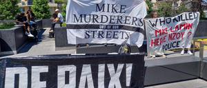 Activists hold banners in front of the criminal court during an appeal trial of six police officers involved in the arrest that led to Mike Ben Peter’s death, in Renens, western Switzerland, on July 8, 2024. 