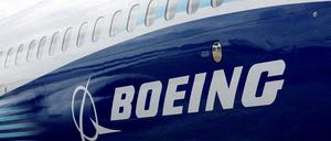 FILE PHOTO: The Boeing logo is seen on the side of a Boeing 737 MAX at the Farnborough International Airshow, in Farnborough, Britain, July 20, 2022.  REUTERS/Peter Cziborra/File Photo