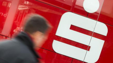 Ein Mann geht an einer Filiale der Sparkasse vorbei.