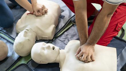 Hands Of A trainee doing chest compression during defibrillator CPR Training.