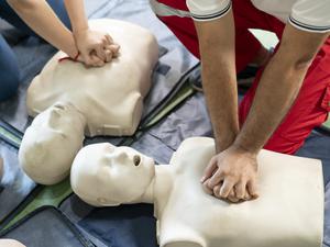 Hands Of A trainee doing chest compression during defibrillator CPR Training.