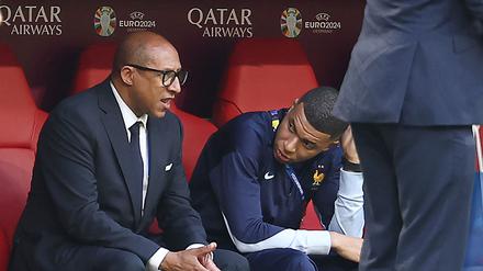French Football Federation President Philippe Diallo speaks with France’s forward Kylian Mbappe.