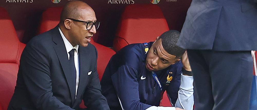 French Football Federation President Philippe Diallo speaks with France’s forward Kylian Mbappe.