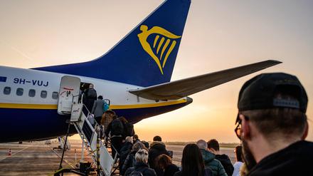 (FILES) Passengers wait to board an aircraft of low cost Irish airline Ryanair at the Berlin-Brandenburg airport in Schoenefeld near Berlin, Germany, on March 13, 2024. 