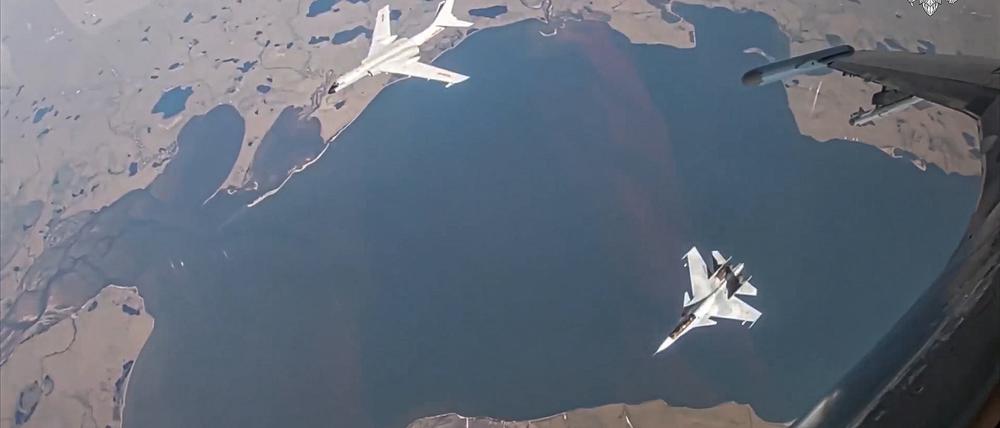 Auf diesem vom Pressedienst des russischen Verteidigungsministeriums über AP veröffentlichten Videostandbild ist ein H-6K-Langstreckenbomber der chinesischen Luftstreitkräfte (oben links) zu sehen. Dieser wird während einer gemeinsamen Luftpatrouille von Russland und China von einem Su-30-Kampfflugzeug der russischen Luftstreitkräfte begleitet. 