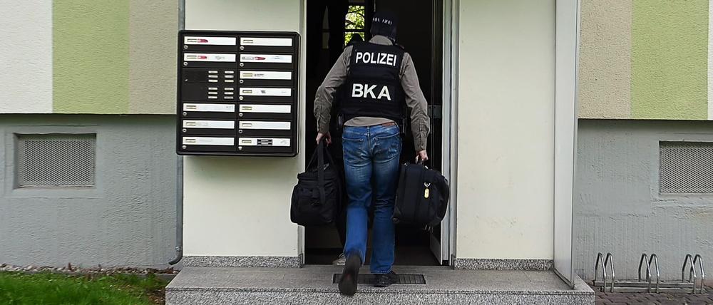Polizisten vom Bundeskriminalamt (BKA) gehen zu einer Durchsuchung in ein Wohnhaus.