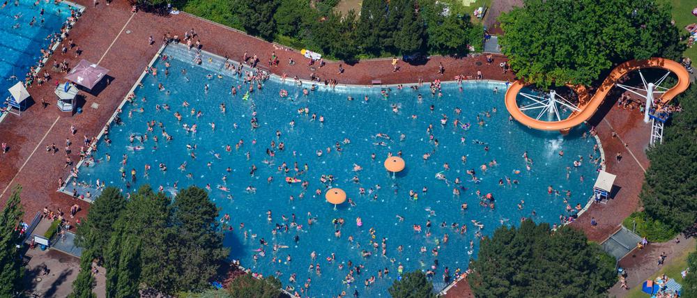 Menschen baden und sonnen sich im Sommerbad am Insulaner im Berliner Bezirk Steglitz.
