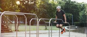 Ein Mann trainiert an einer Freiluft-Fitnessanlage (Symbolbild).