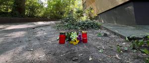 Vor dem Haus in Zehlendorf erinnern Grablichter und Blumen an die getötete Frau.