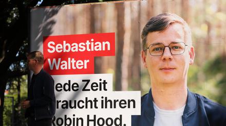 Sebastian Walter, Die Linke, Landesvorsitzender und Spitzenkandidat, steht vor einem Großflächenplakat mit einem Foto von Sebastian Walter. 