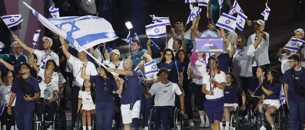Der Rollstuhltennisspieler Adam Berdichevsky trägt bei der Eröffnungsfeier der Paralympics in Paris die Fahne Israels.