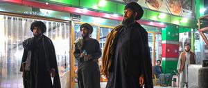Taliban security personnel stand outside a restaurant in Kandahar on August 25, 2024. (Photo by Wakil Kohsar / AFP)