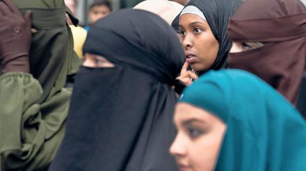 Mit Kopftuch oder Burka verschleierte Frauen.