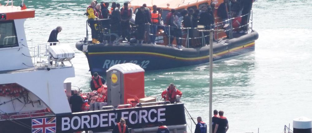 Eine Gruppe von Menschen, bei denen es sich vermutlich um Migranten handelt, wird nach einem Zwischenfall mit einem kleinen Boot im Ärmelkanal an Bord des RNLI-Rettungsboots Dungeness nach Dover (Kent) gebracht.