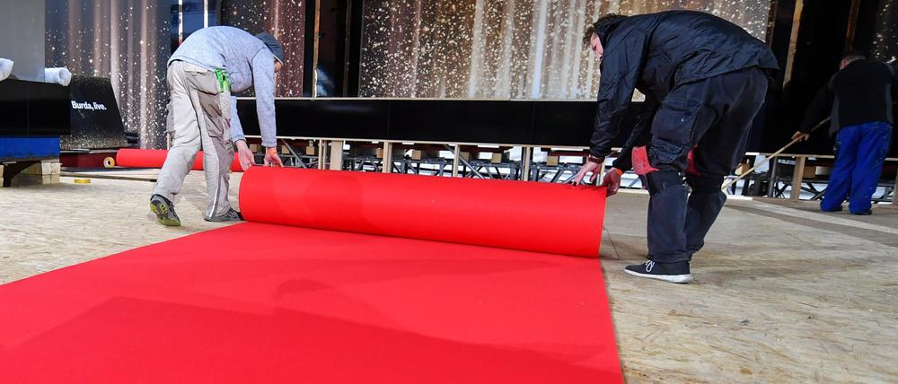 Ein roter Teppich wird ausgerollt.