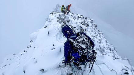 Rettungsspezialisten bei einem Einsatz, um zwei nur mit Turnschuhen und Baumwollhose ausgestattete Vietnamesen vom Matterhorn zu retten.