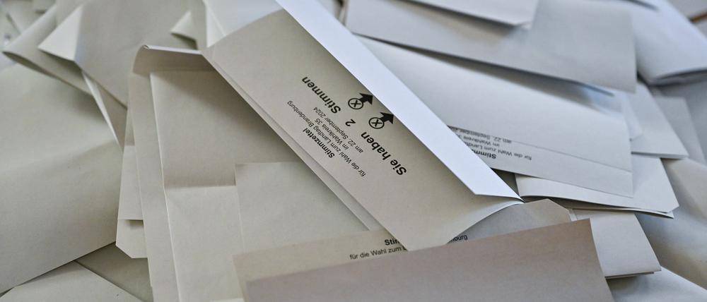 Aus einer Wahlurne ausgeschüttete Stimmzettel für die Landtagswahl in Brandenburg liegen nach Ende der Wahl auf einem Tisch. 