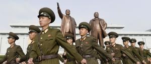 15.04.2018, Nordkorea, Pjöngjang: Nordkoreanische Soldaten besuchen die Statuen von Kim Il Sung (l) und Kim Jong Il am Großmonument Mansudae anlässlich des 106. Geburtstages von Kim Il Sung.