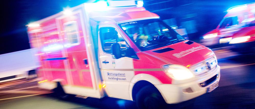 Ein Rettungswagen der Feuerwehr fährt mit Blaulicht durch eine Straße (Symbolbild)