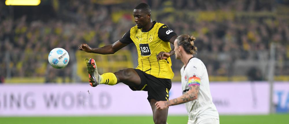 Serhou Guirassy von Borussia Dortmund und Jackson Irvine vom FC St. Pauli im Zweikampf.