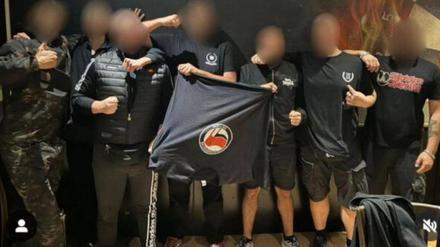 Rechtsradikale posieren mit einem Antifa-Shirt in der Hand.